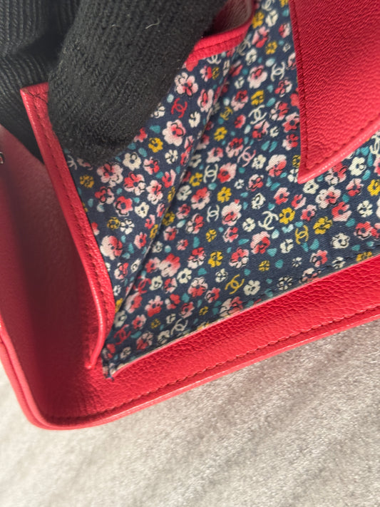 Back of red Chanel wallet with zippered pocket