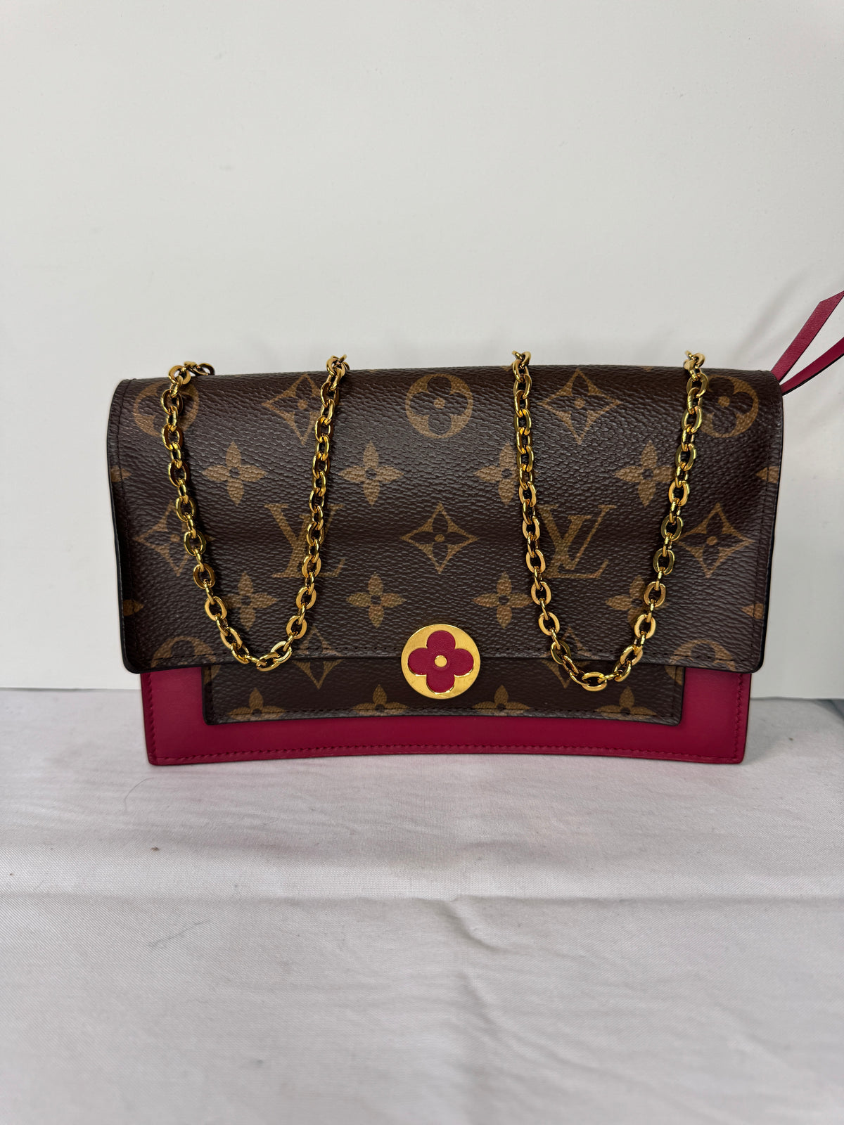 Front of Louis Vuitton brown monogram shoulder bag with burgundy accents and gold-tone chain