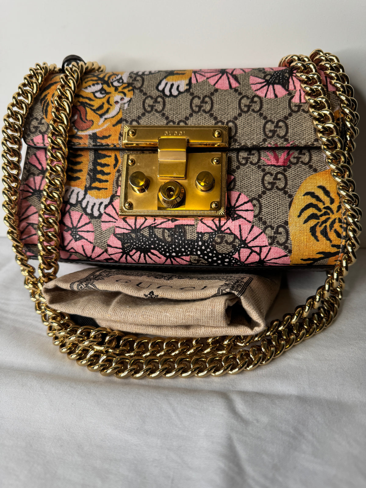 Front of Gucci GG monogram tiger and pink floral print bag with gold-tone chain strap