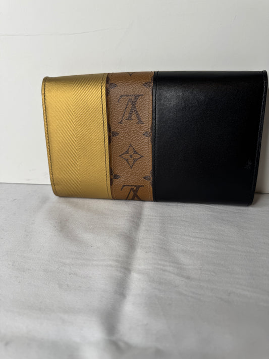 Front of Louis Vuitton black and gold monogram clutch with LV clasp and circular stud detailing