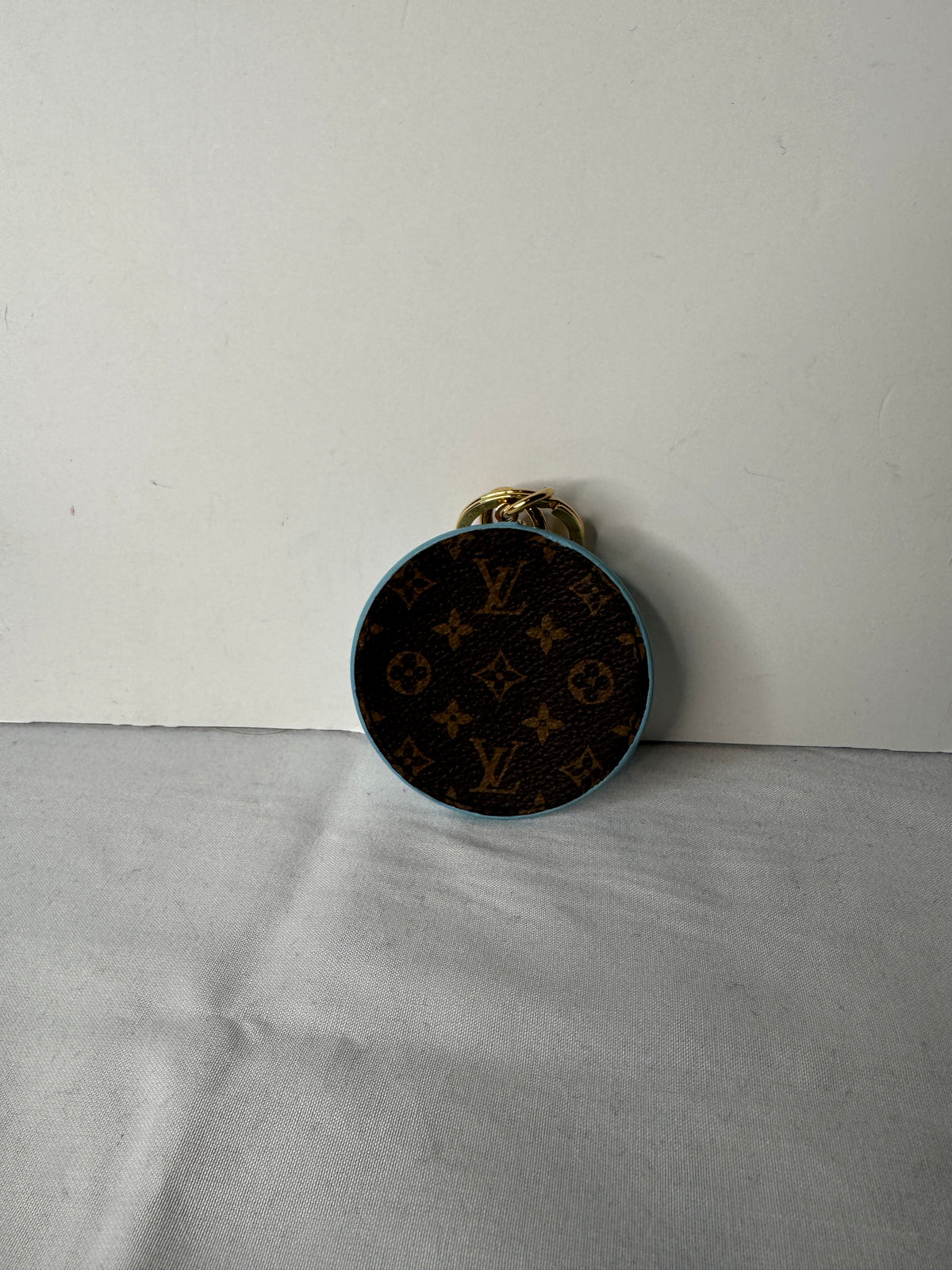 Brown Louis Vuitton Monogram reverse of round bag charm with light blue edging