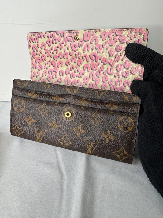 Wallet closed, resting on a Louis Vuitton dust bag