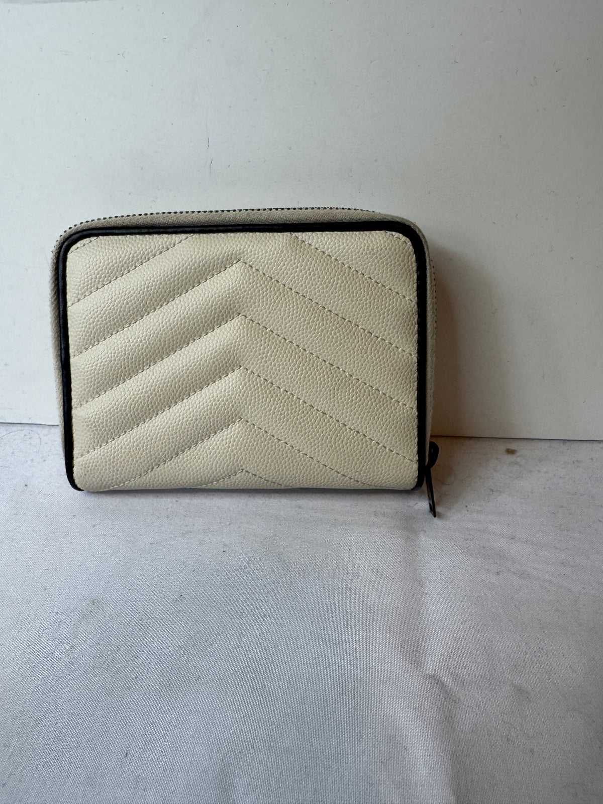 Front of ivory chevron quilted wallet with black YSL monogram