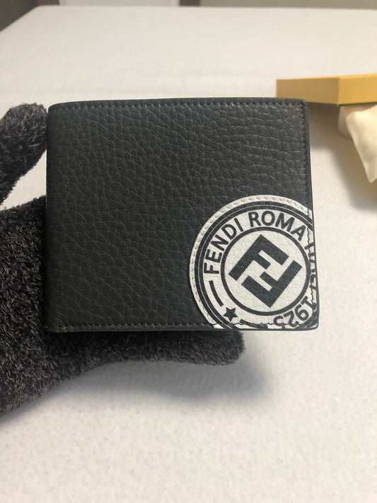 Black Fendi Roma stamp bifold wallet resting in an open Fendi box with dust bag